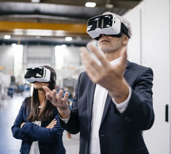 man and woman wearing VR goggles
